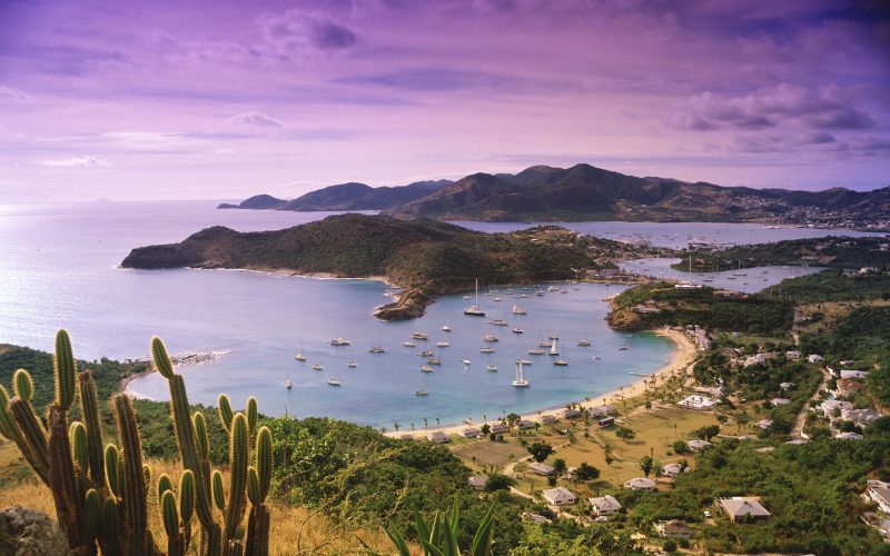 AP0E4C Bird s eye view of Nelson's Dockyard surrounding mountains coves and aqua blue water of the island of Antigua