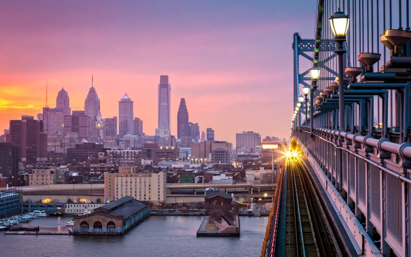 Philadelphia,Under,A,Hazy,Purple,Sunset.,An,Incoming,Train,Crosses