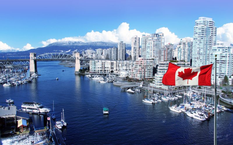 Canadian,Flag,In,Front,Of,View,Of,False,Creek,And